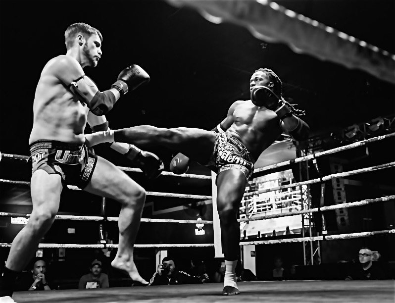 Stacey throwing a kick in a Muay Thai fight